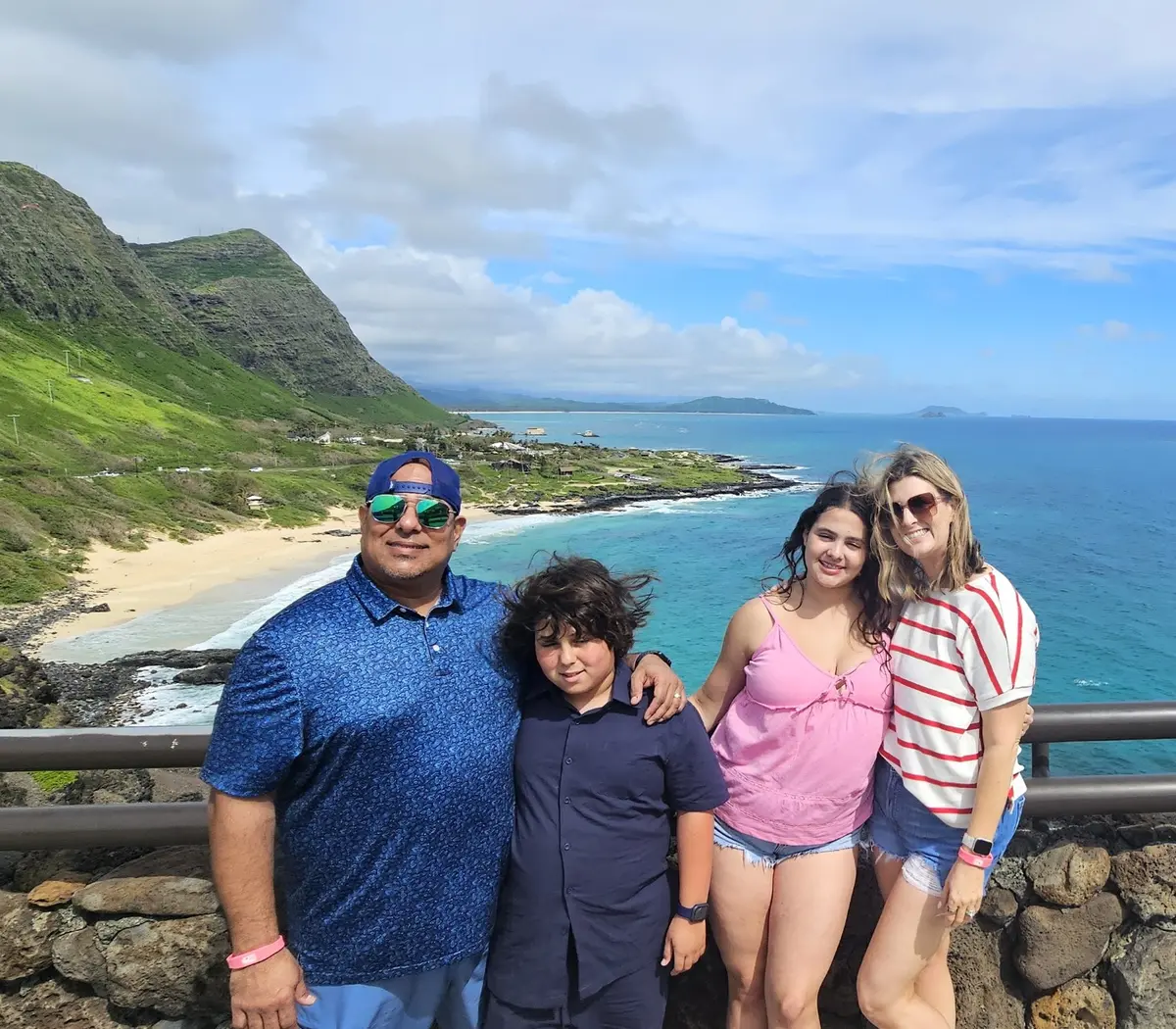 A family at a scenic Oʻahu coastline viewpoint