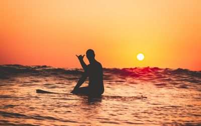 surfing at sunset Oahu Hawaii