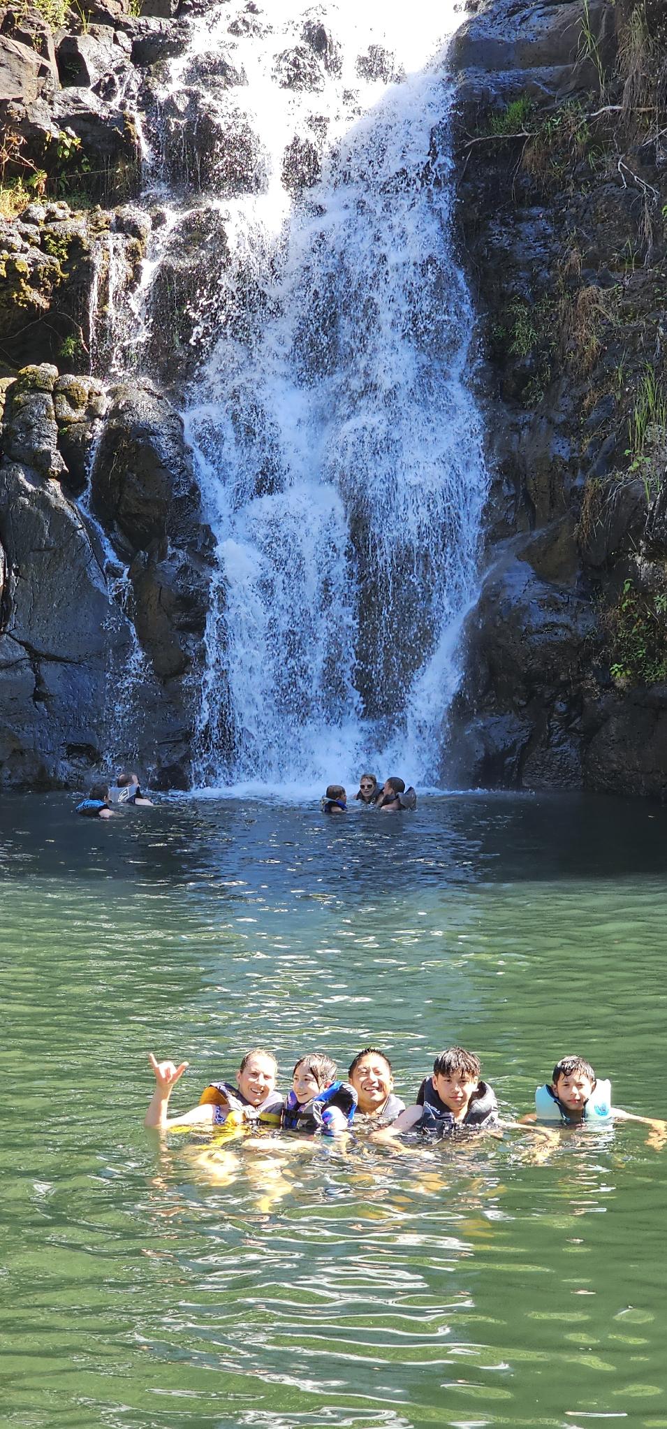 Visitors swimming at Waimea Falls in Waimea Valley on Oahu